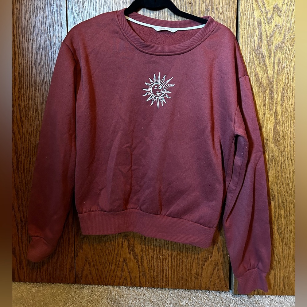 Red sweatshirt with white sun and moon print size medium.